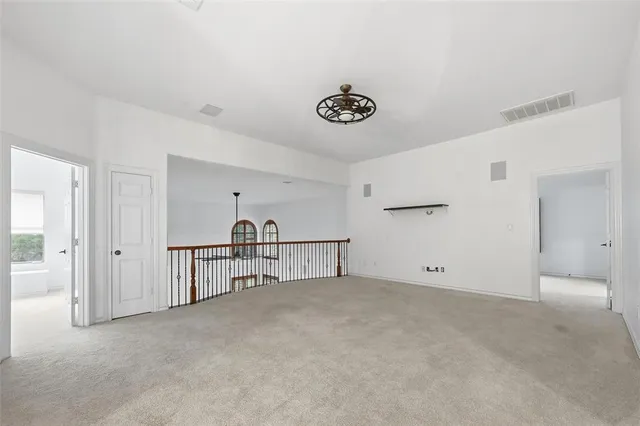 a spacious bedroom with a large bed and a large window