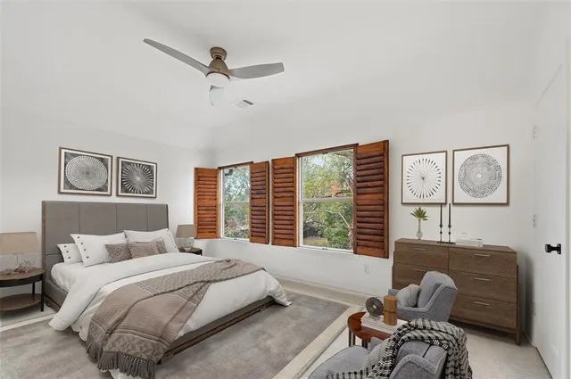 an aerial view of residential houses with outdoor space and trees