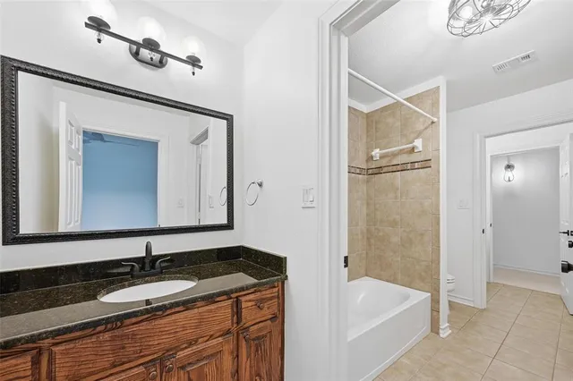 a spacious bathroom with a granite countertop sink mirror and a
