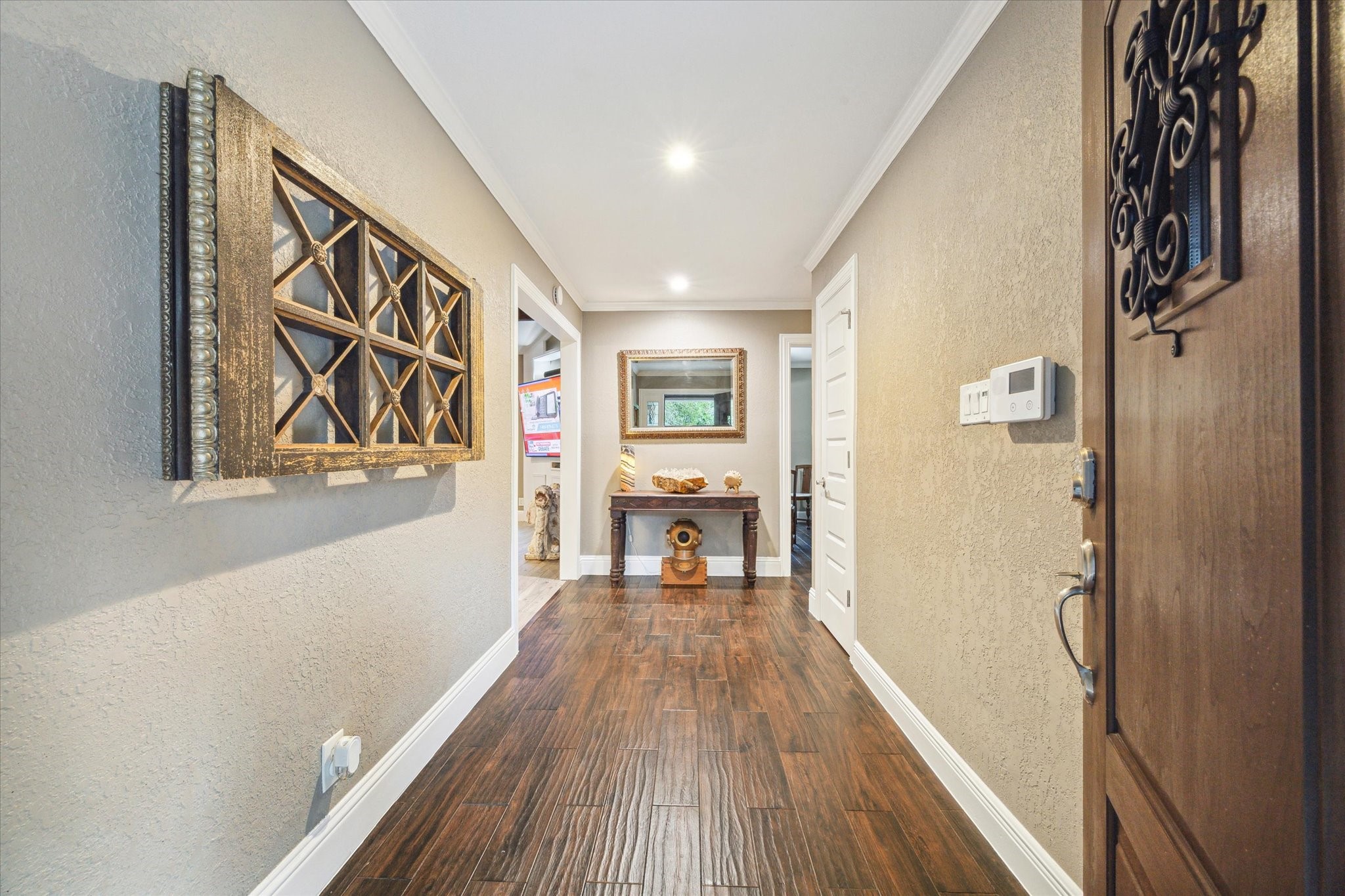 5 Tree Frog Drive Houston, TX 77074 - Photo 6 of 35 a view of a hallway with wooden floor and furniture