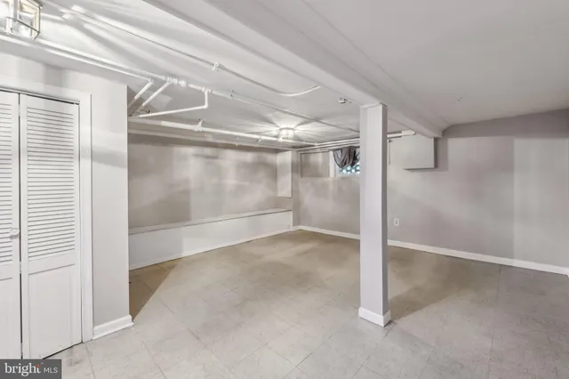 a kitchen with granite countertop a refrigerator stove and oven with wooden floor
