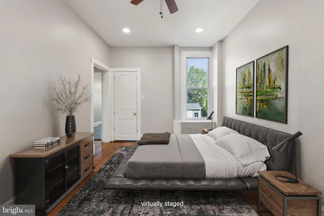 a bedroom with a bed and a large window