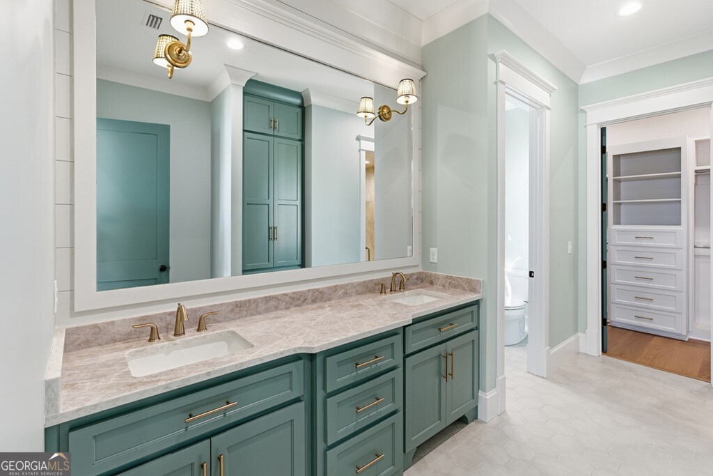 5909 Travis Trail Lake Park, GA 31636 - Photo 13 of 46 a bathroom with a granite countertop sink double vanity and a mirror