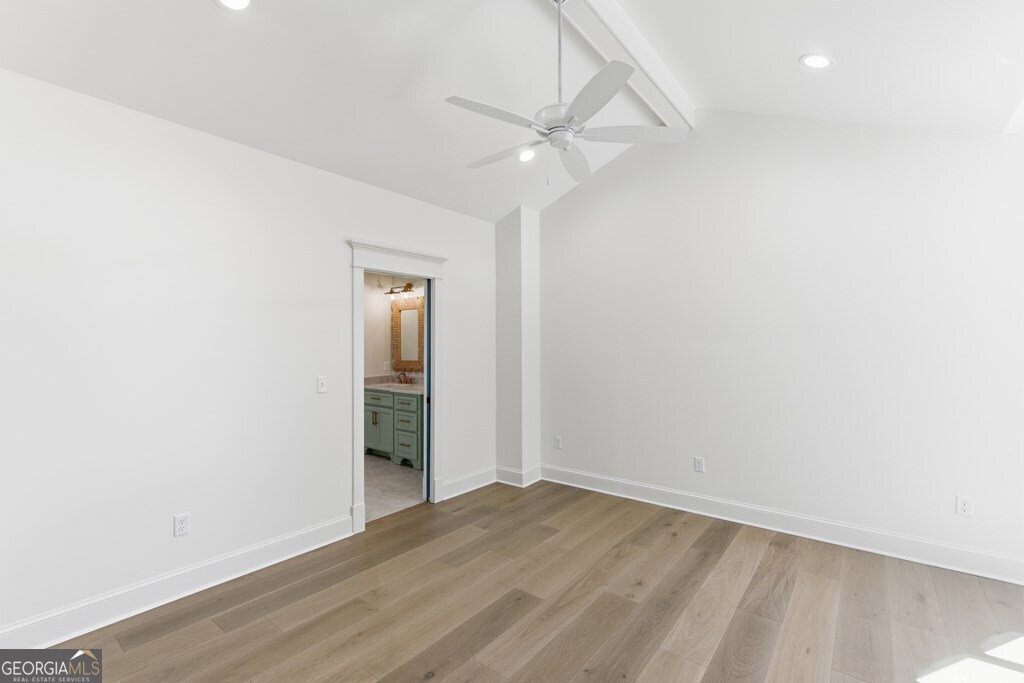 5909 Travis Trail Lake Park, GA 31636 - Photo 20 of 46 an empty room with wooden floor and fan