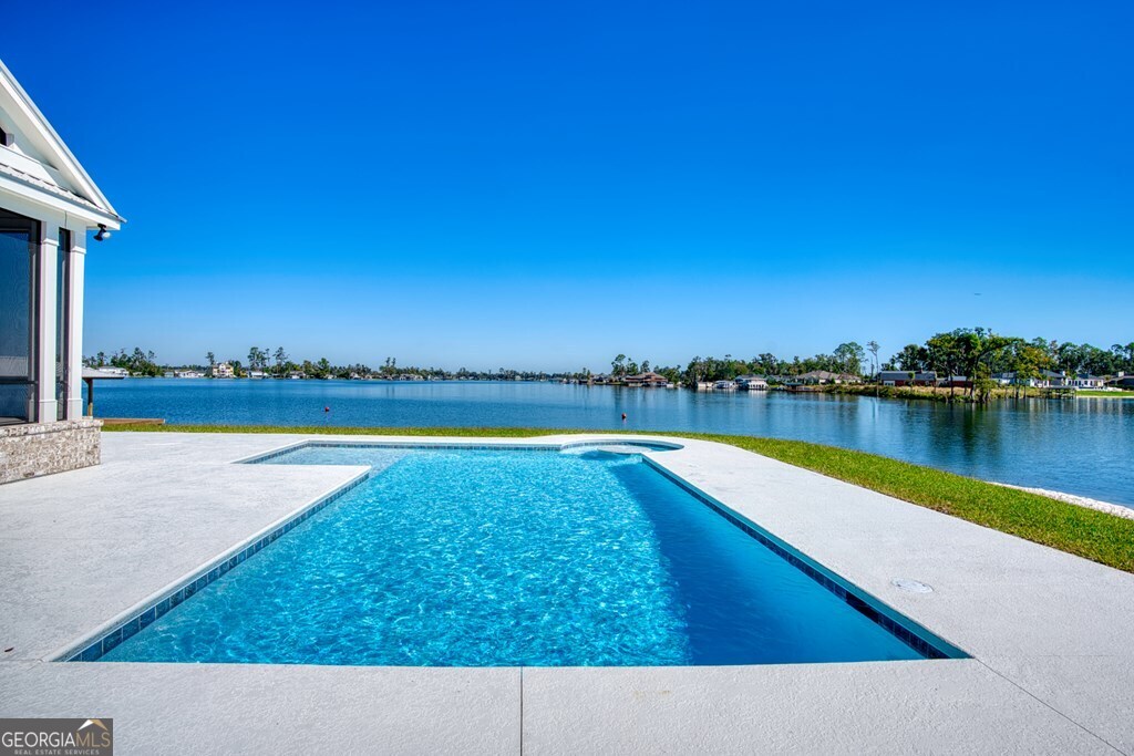 5909 Travis Trail Lake Park, GA 31636 - Photo 34 of 46 a view of swimming pool with a yard and lake view