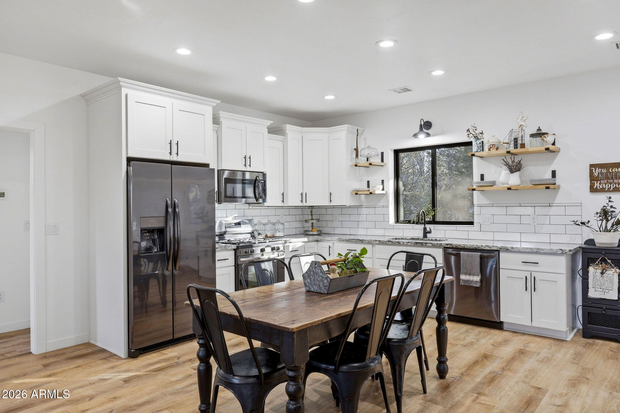 2225 Roundabout Way Overgaard, AZ 85933 - Photo 6 of 32 a kitchen with stainless steel appliances granite countertop a dining table chairs stove refrigerator and cabinets