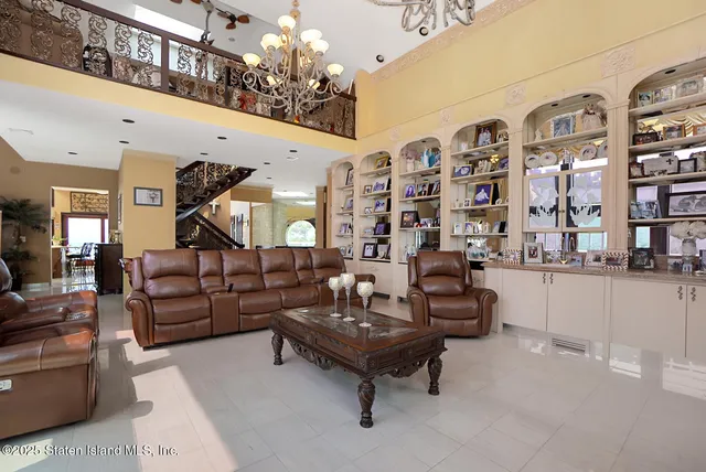 a living room with furniture and chandelier