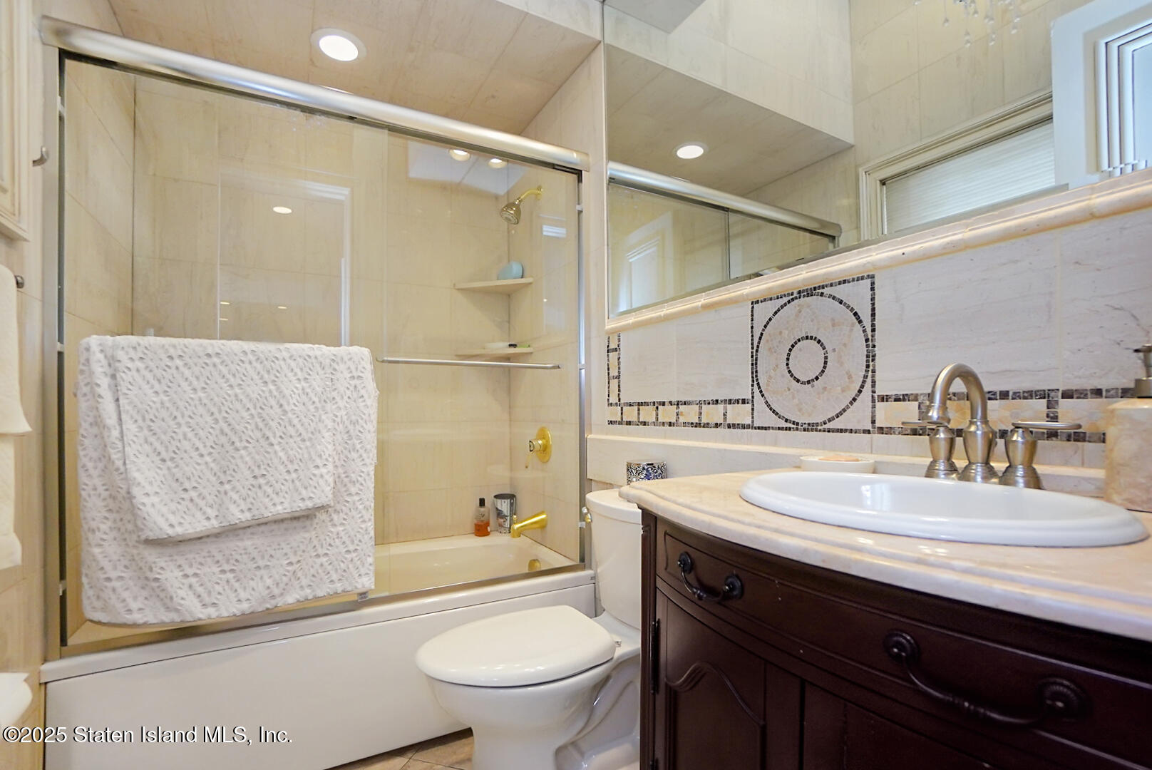 545 Arbutus Avenue Staten Island, NY 10312 - Photo 20 of 57 a bathroom with a sink a toilet and shower