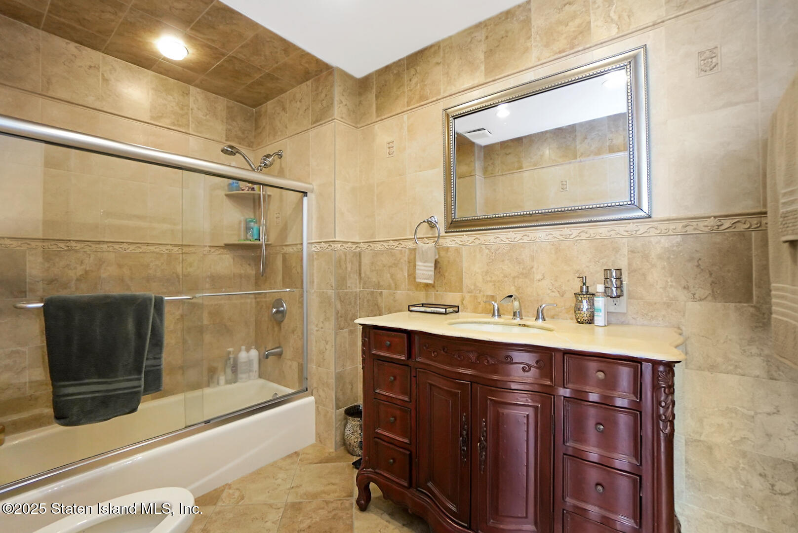 545 Arbutus Avenue Staten Island, NY 10312 - Photo 21 of 57 a bathroom with a sink a toilet and shower