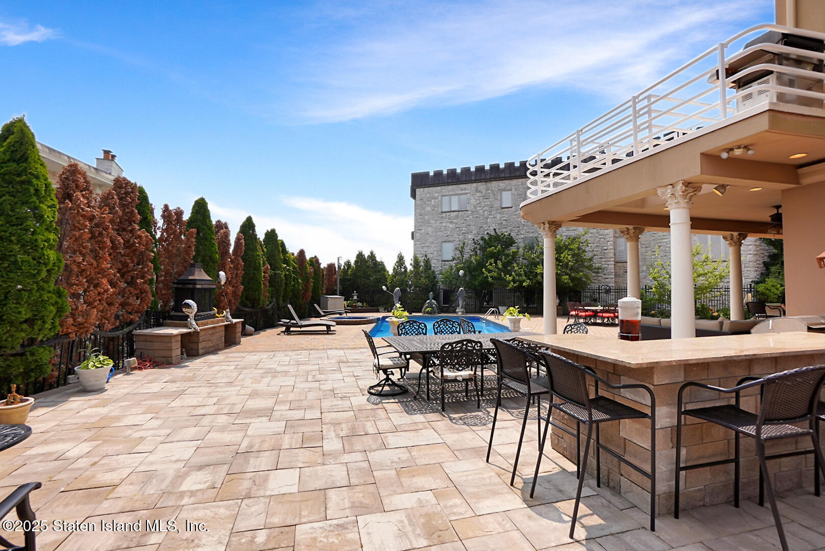 545 Arbutus Avenue Staten Island, NY 10312 - Photo 22 of 57 a view of a patio with dining table and chairs with a barbeque grill and plants