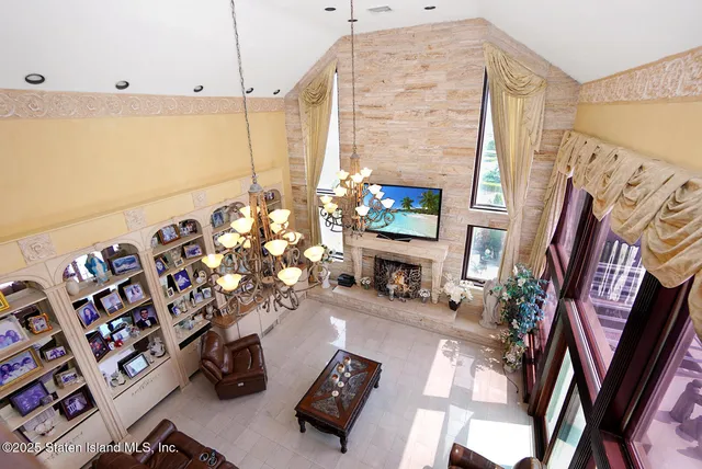 a living room with furniture and a floor to ceiling window