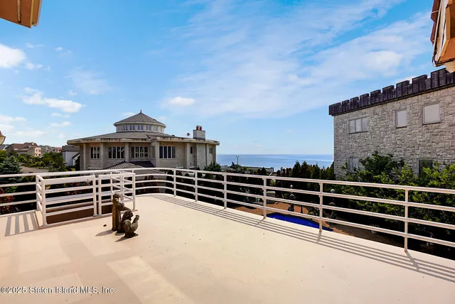 a view of a roof deck with couches and sky view
