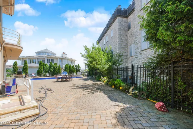 a view of a patio with couches and table and chairs and potted plants