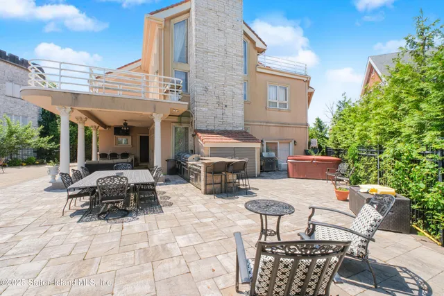 a view of a house with swimming pool and sitting area