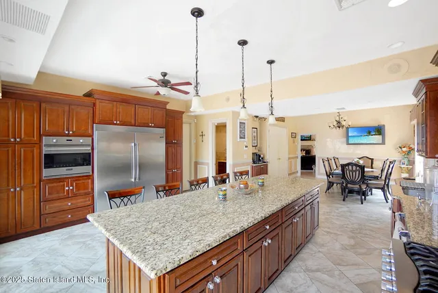 a kitchen with granite countertop a sink counter top space appliances and cabinets