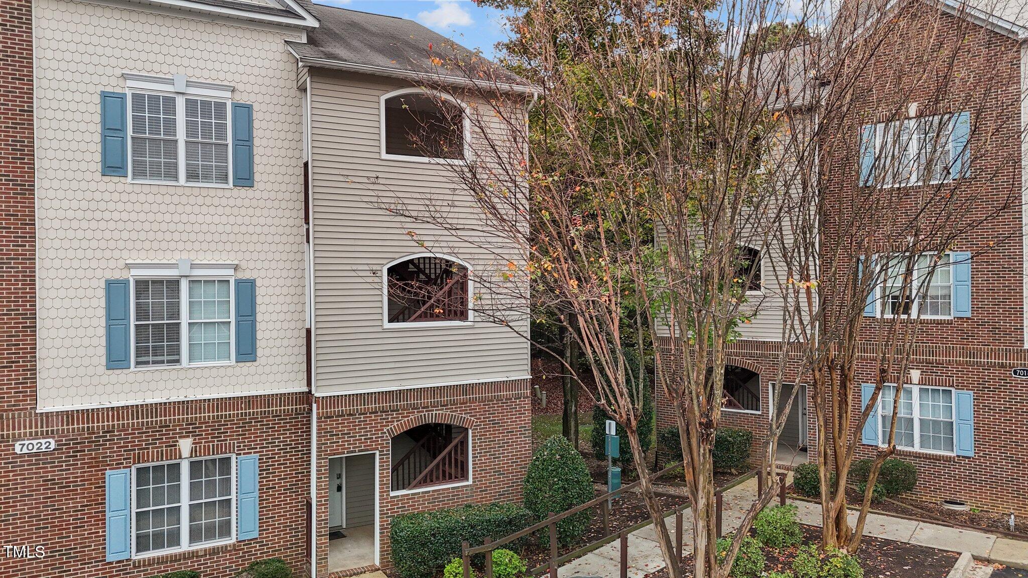 7022 Sandy Forks Road, Unit 101 Raleigh, NC 27615 - Photo 1 of 40 a view of a house with a yard