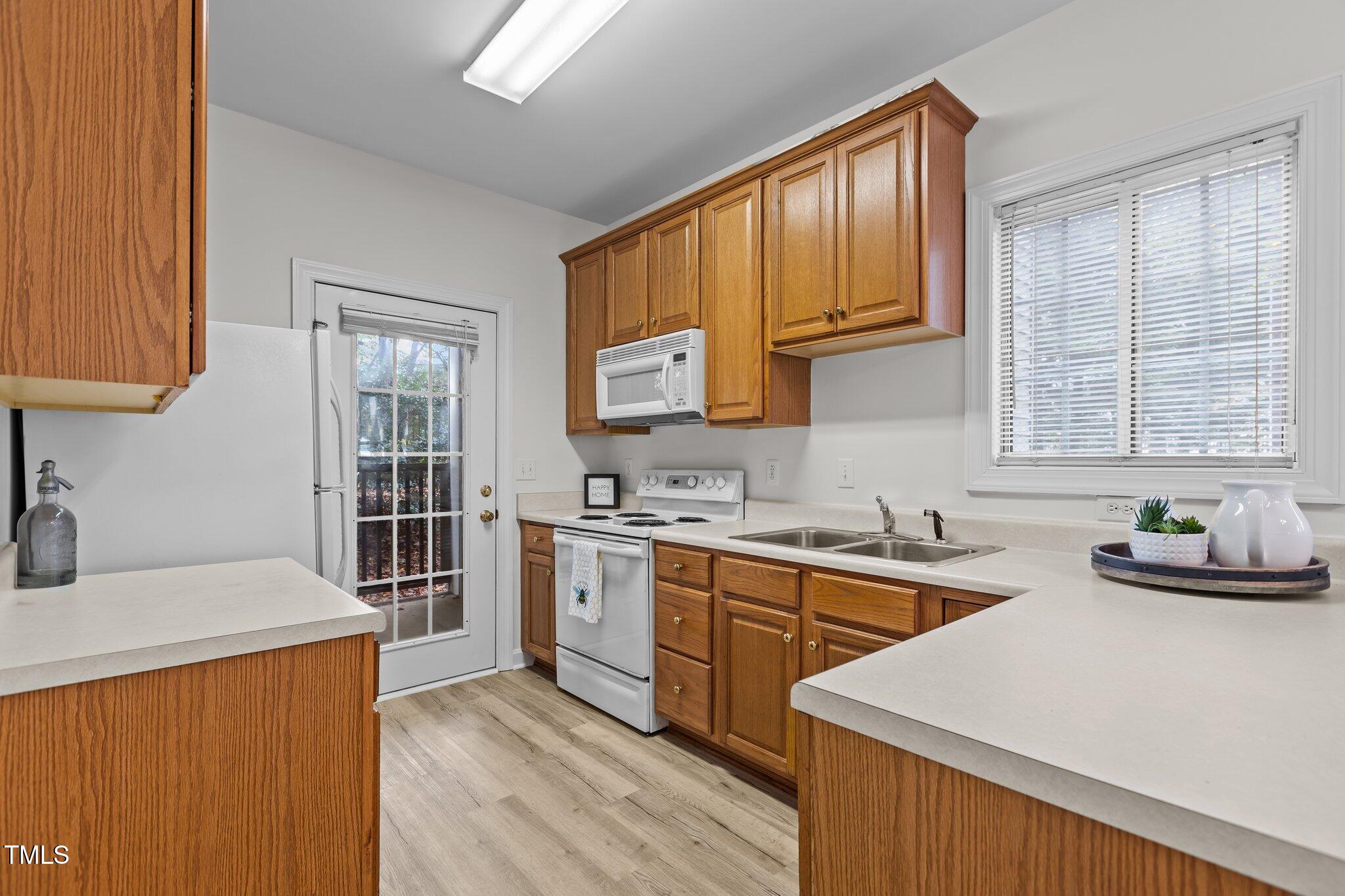 7022 Sandy Forks Road, Unit 101 Raleigh, NC 27615 - Photo 12 of 40 a kitchen with stainless steel appliances a sink stove and cabinets