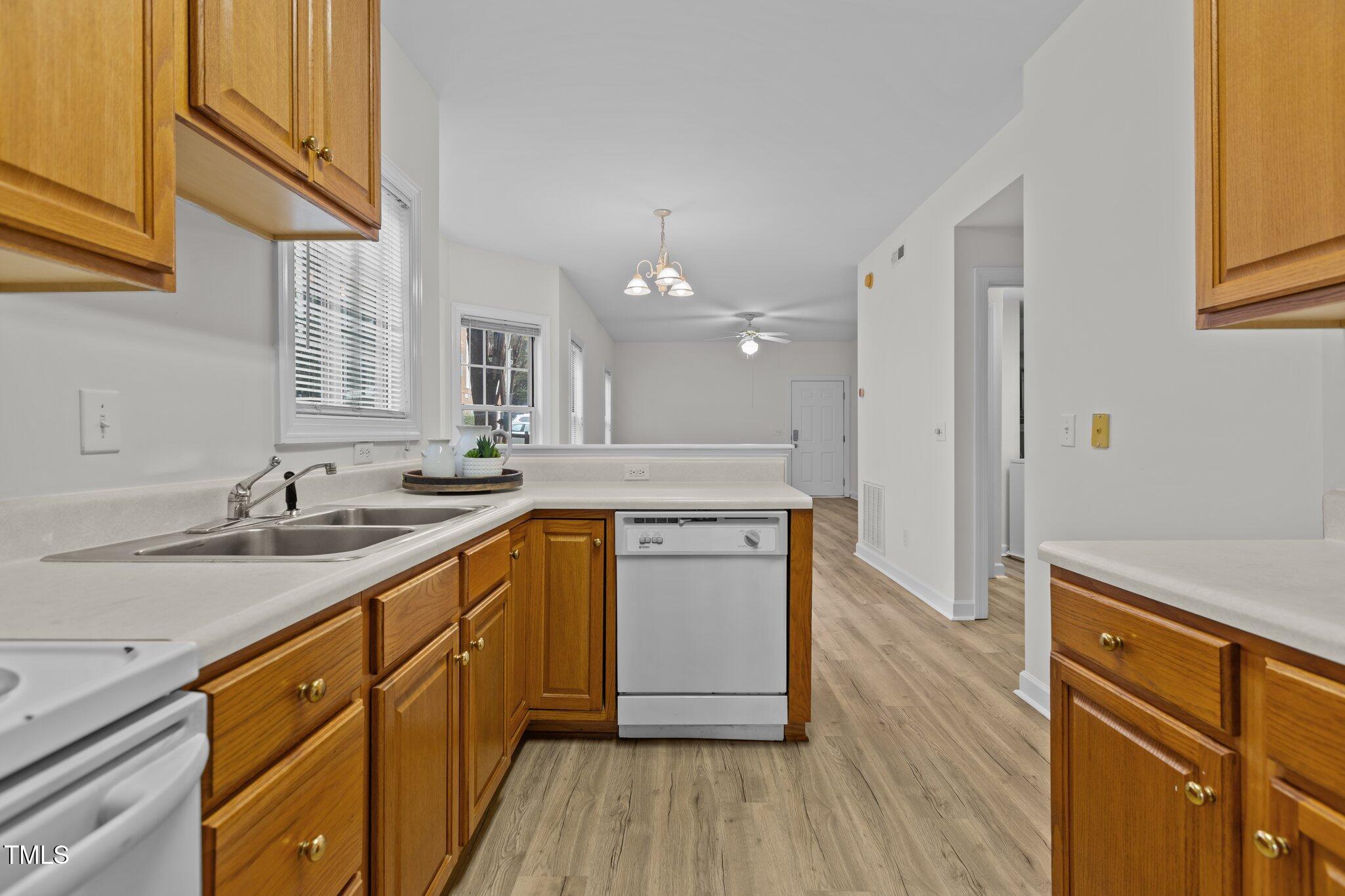 7022 Sandy Forks Road, Unit 101 Raleigh, NC 27615 - Photo 14 of 40 a kitchen with a sink stove and cabinets