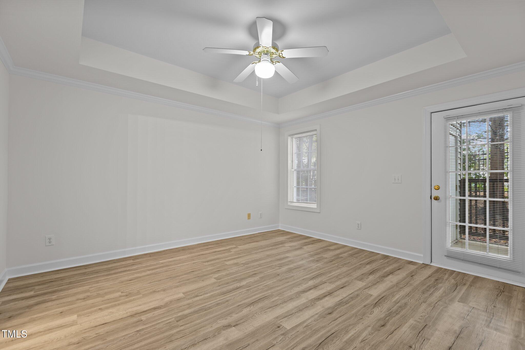 7022 Sandy Forks Road, Unit 101 Raleigh, NC 27615 - Photo 16 of 40 a view of an empty room with a window and wooden floor