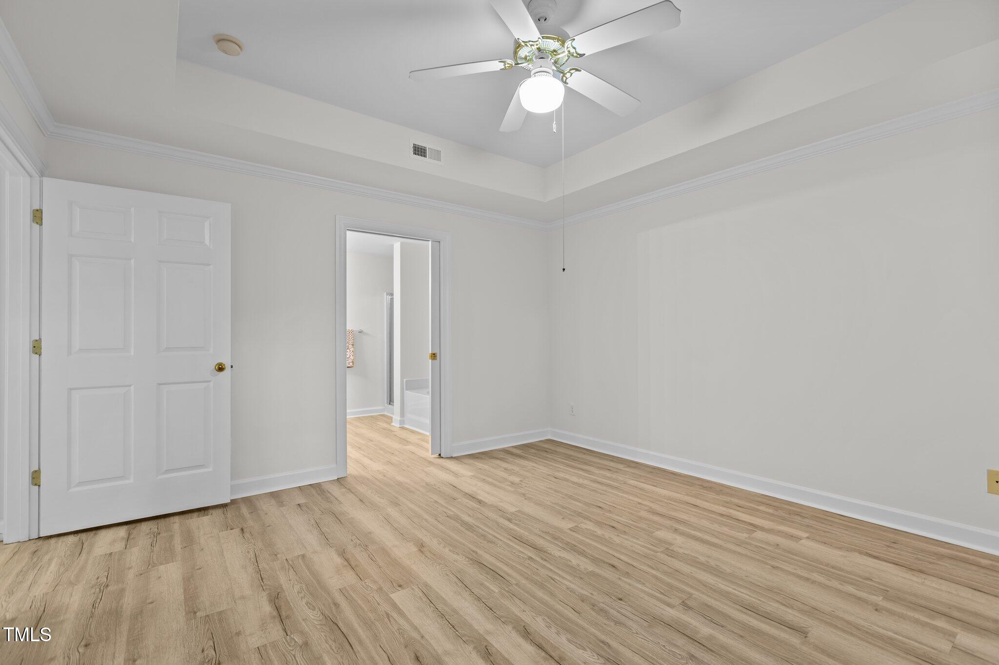 7022 Sandy Forks Road, Unit 101 Raleigh, NC 27615 - Photo 17 of 40 a view of an empty room with wooden floor
