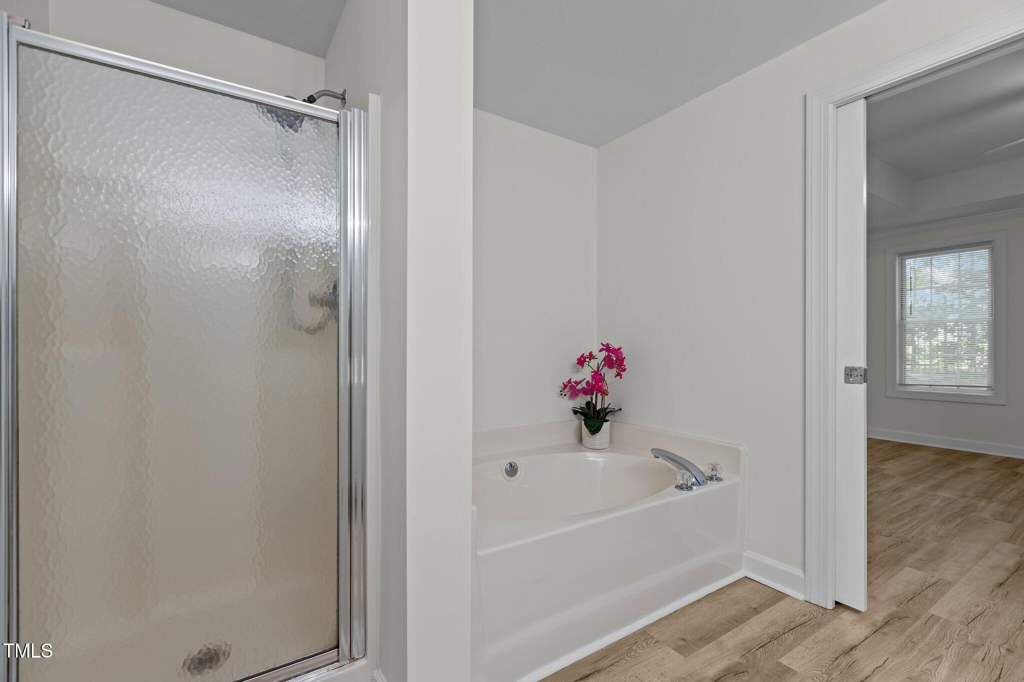7022 Sandy Forks Road, Unit 101 Raleigh, NC 27615 - Photo 19 of 40 a white bath tub with a shower