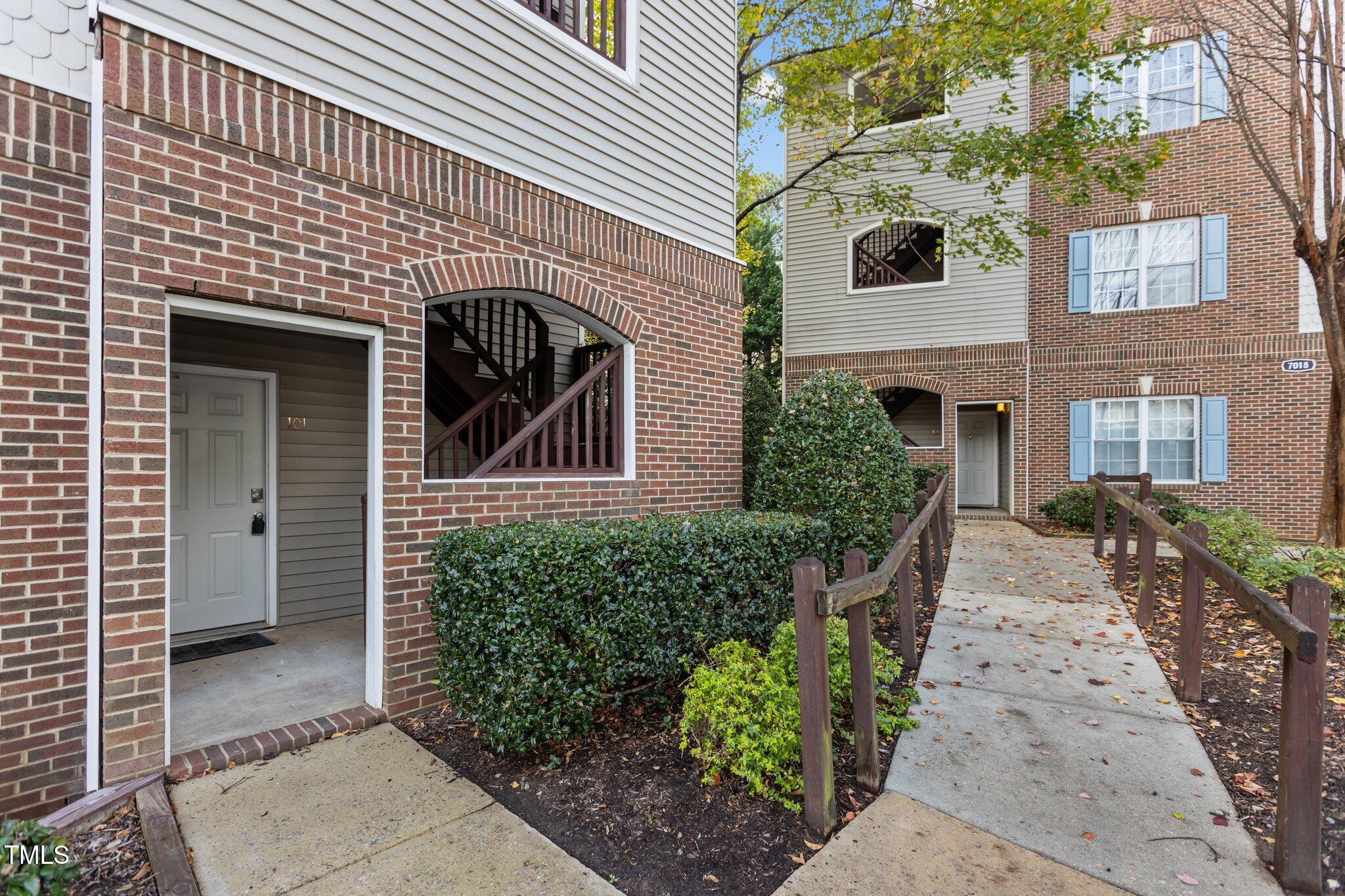 7022 Sandy Forks Road, Unit 101 Raleigh, NC 27615 - Photo 2 of 40 a front view of a house with garden