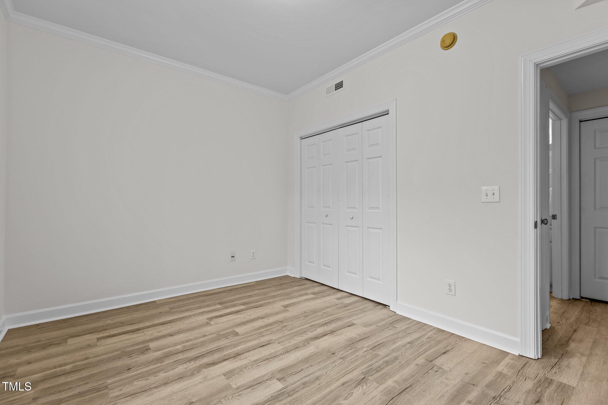 7022 Sandy Forks Road, Unit 101 Raleigh, NC 27615 - Photo 22 of 40 a view of empty room with wooden floor