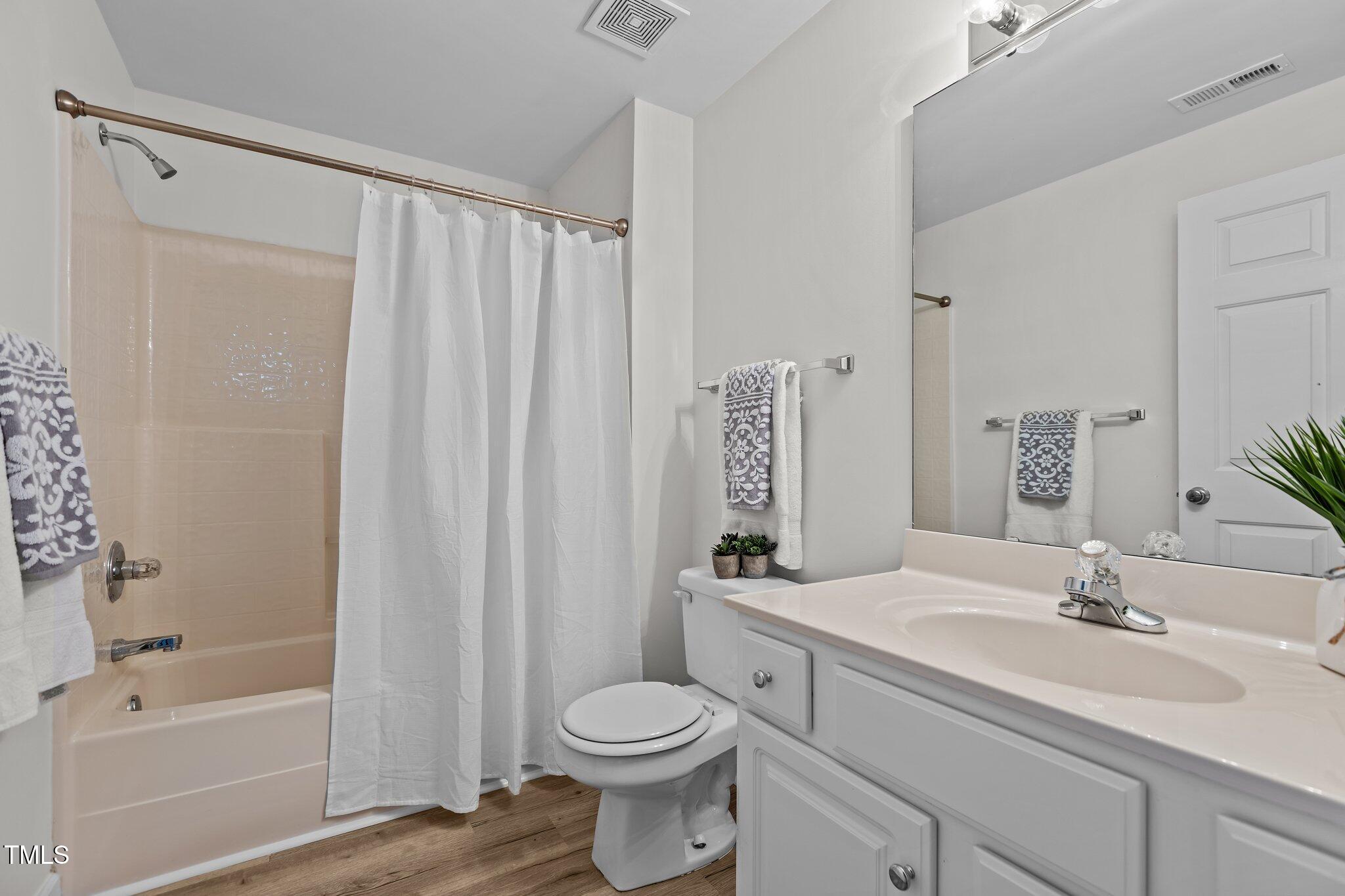 7022 Sandy Forks Road, Unit 101 Raleigh, NC 27615 - Photo 23 of 40 a bathroom with a sink toilet and shower