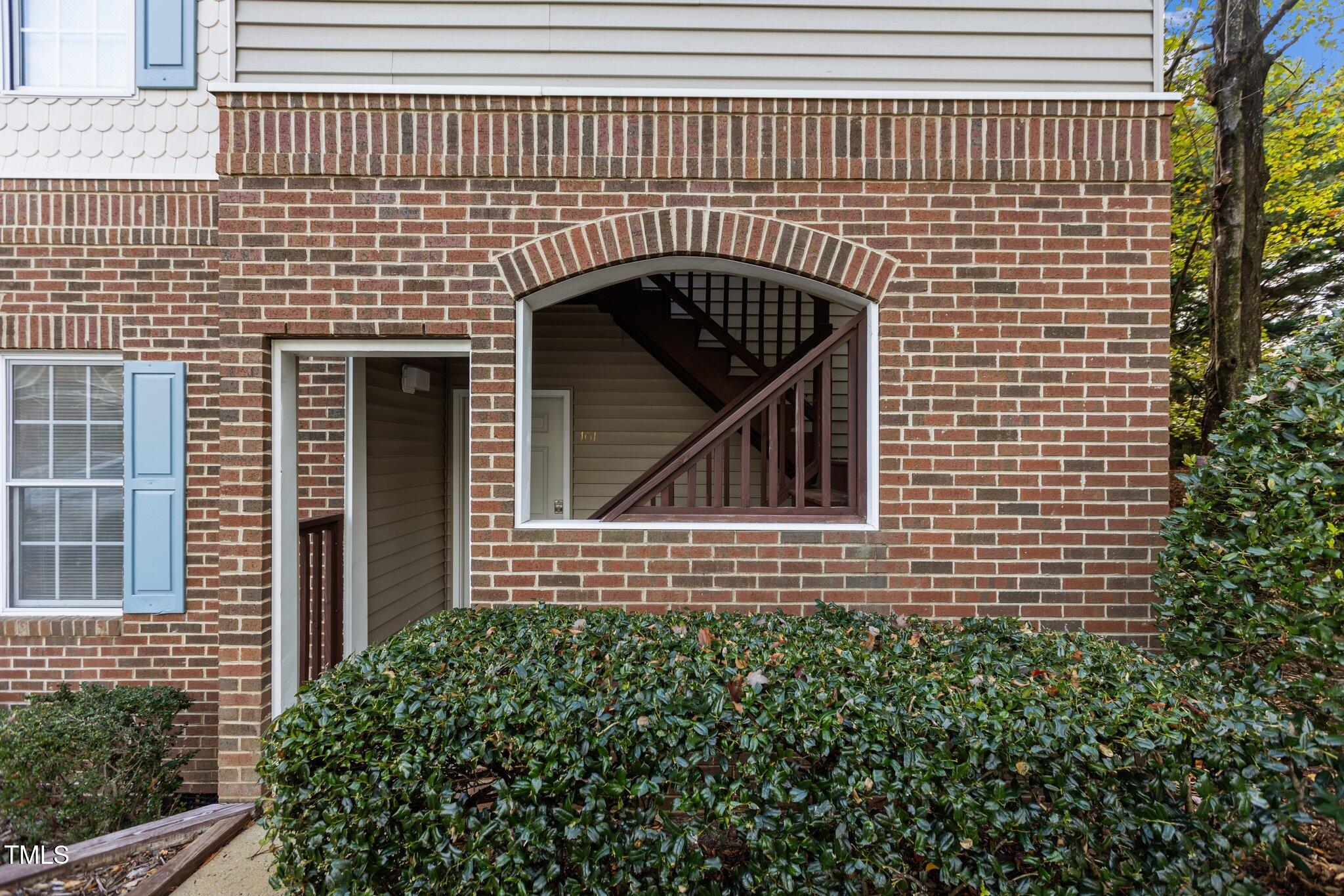 7022 Sandy Forks Road, Unit 101 Raleigh, NC 27615 - Photo 27 of 40 a view of brick house with large windows