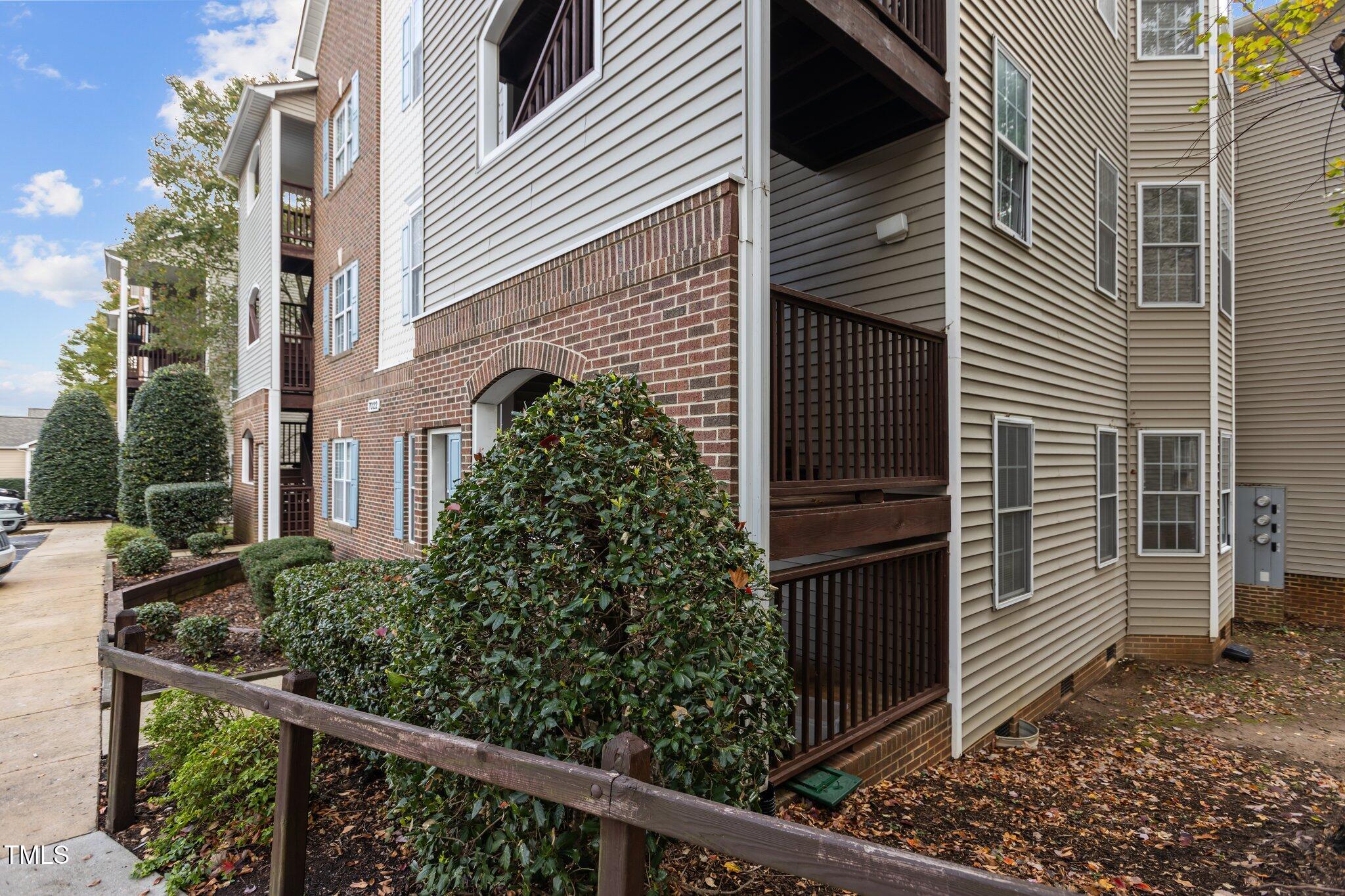 7022 Sandy Forks Road, Unit 101 Raleigh, NC 27615 - Photo 28 of 40 a view of a house with a window and wooden fence