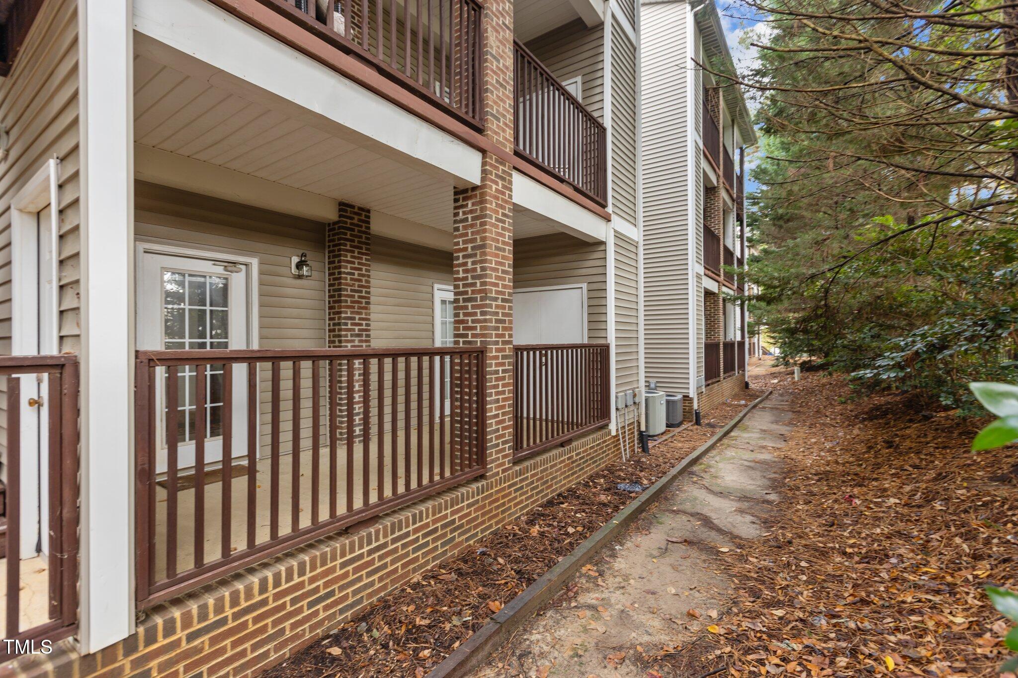 7022 Sandy Forks Road, Unit 101 Raleigh, NC 27615 - Photo 29 of 40 a view of a brick house with a small yard