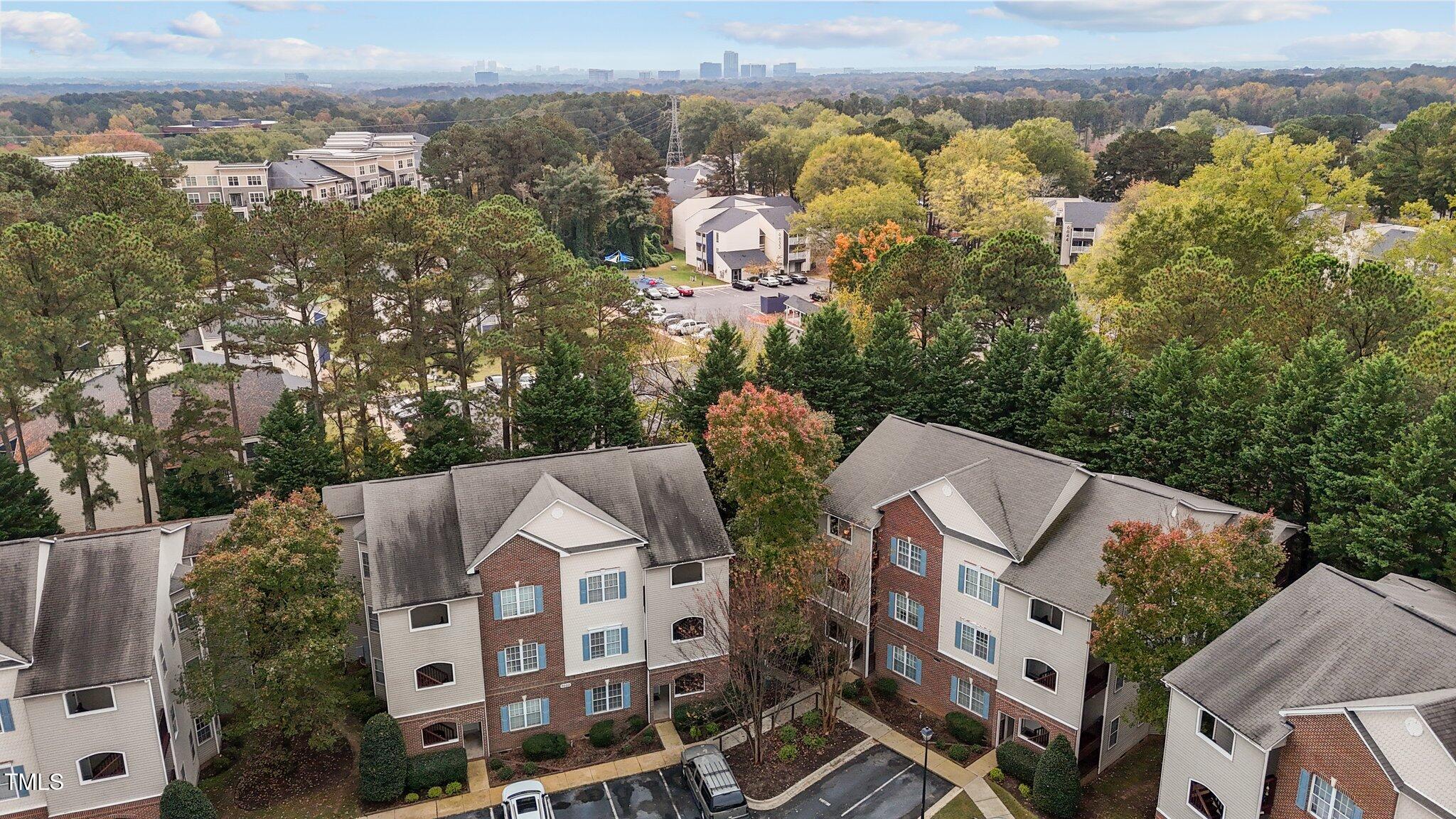 7022 Sandy Forks Road, Unit 101 Raleigh, NC 27615 - Photo 33 of 40 an aerial view of residential house with outdoor space and trees