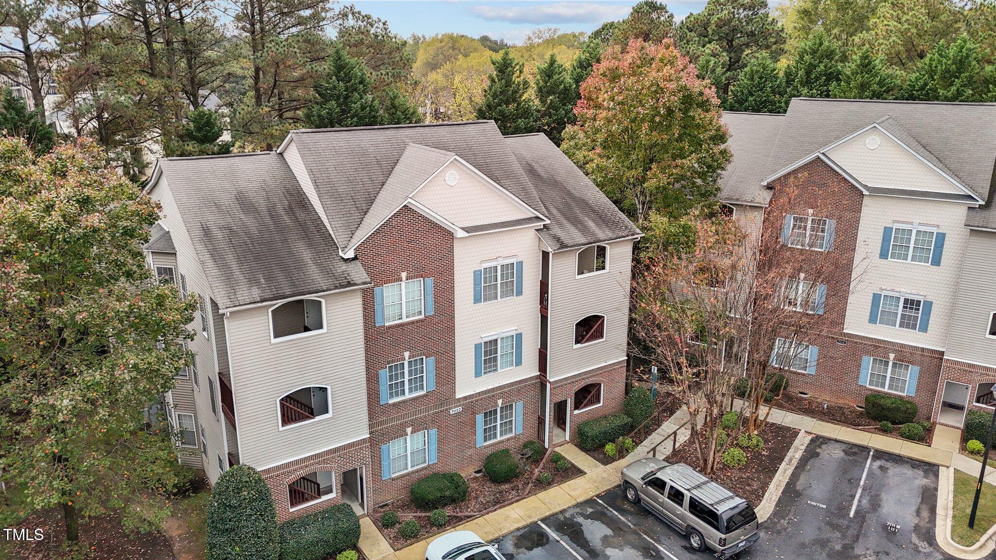 7022 Sandy Forks Road, Unit 101 Raleigh, NC 27615 - Photo 4 of 40 a aerial view of a residential apartment building with a yard
