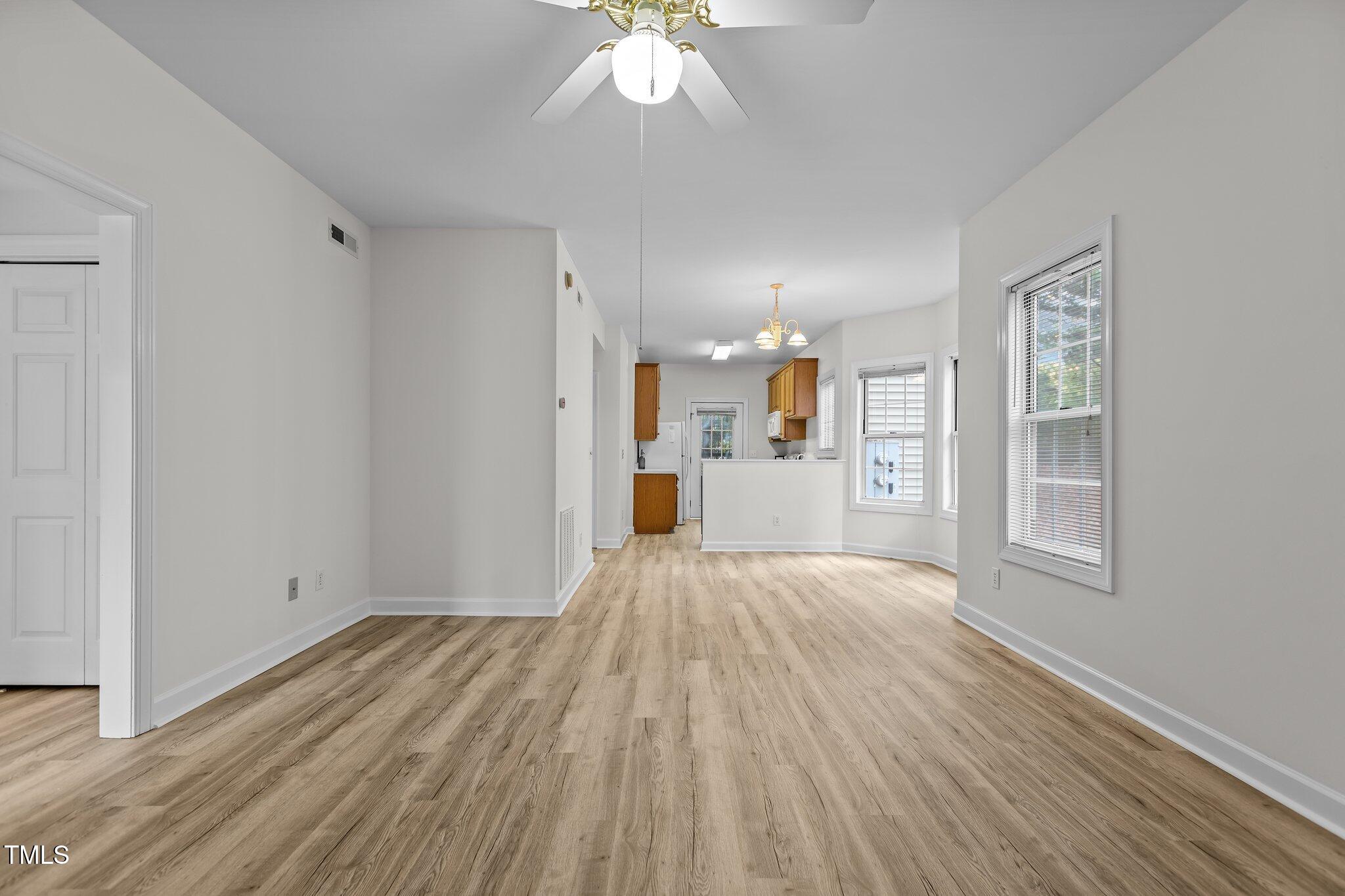 7022 Sandy Forks Road, Unit 101 Raleigh, NC 27615 - Photo 7 of 40 a view of a room with wooden floor and a window