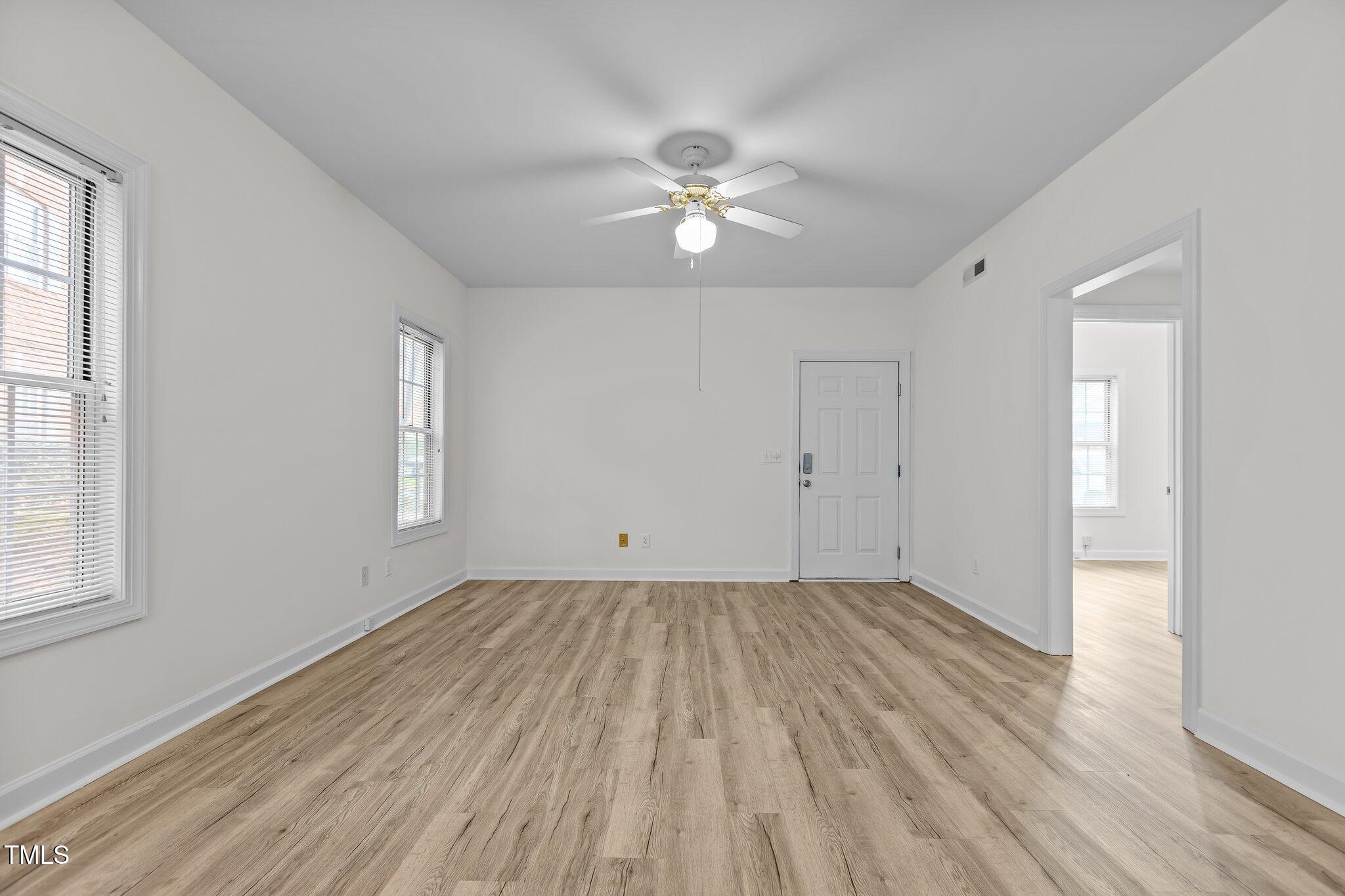 7022 Sandy Forks Road, Unit 101 Raleigh, NC 27615 - Photo 8 of 40 wooden floor in an empty room with a window