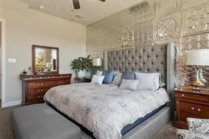 a bedroom with a bed and lamp on dresser