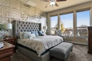 a bedroom with a large bed and a chandelier