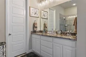 a bathroom with a double vanity sink and a mirror