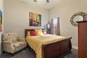 a bedroom with a bed couch and window