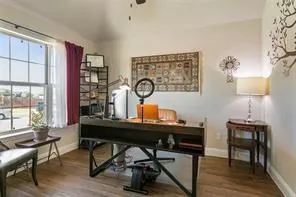 a view of a workspace with furniture and a window