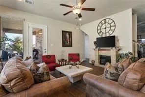 a living room with furniture a fireplace and a flat screen tv