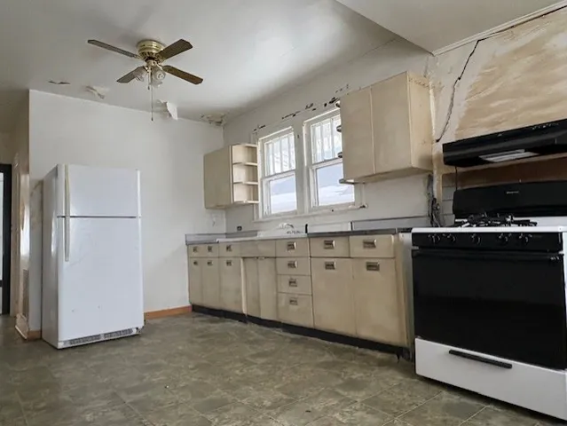 a kitchen with cabinets stainless steel appliances and a window
