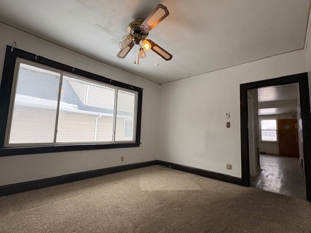 10607 South May Street Chicago, IL 60643 - Photo 4 of 15 an empty room with windows and chandelier fan