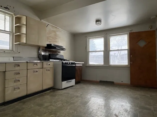 a kitchen with appliances cabinets and a window