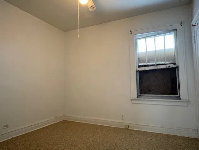 an empty room with a fireplace