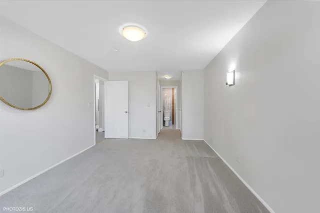 a view of a room with wooden floor and a chandelier