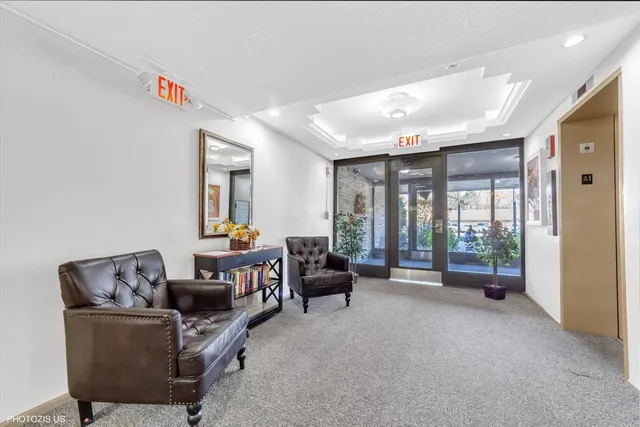 a living room with furniture and large windows