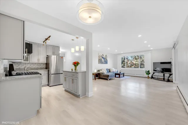 a living room with furniture and a kitchen