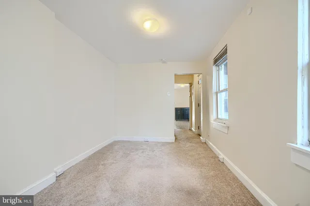 a bathroom with a sink a toilet and a window