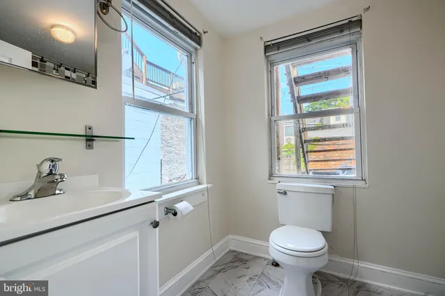a bathroom with a sink a mirror and a shower
